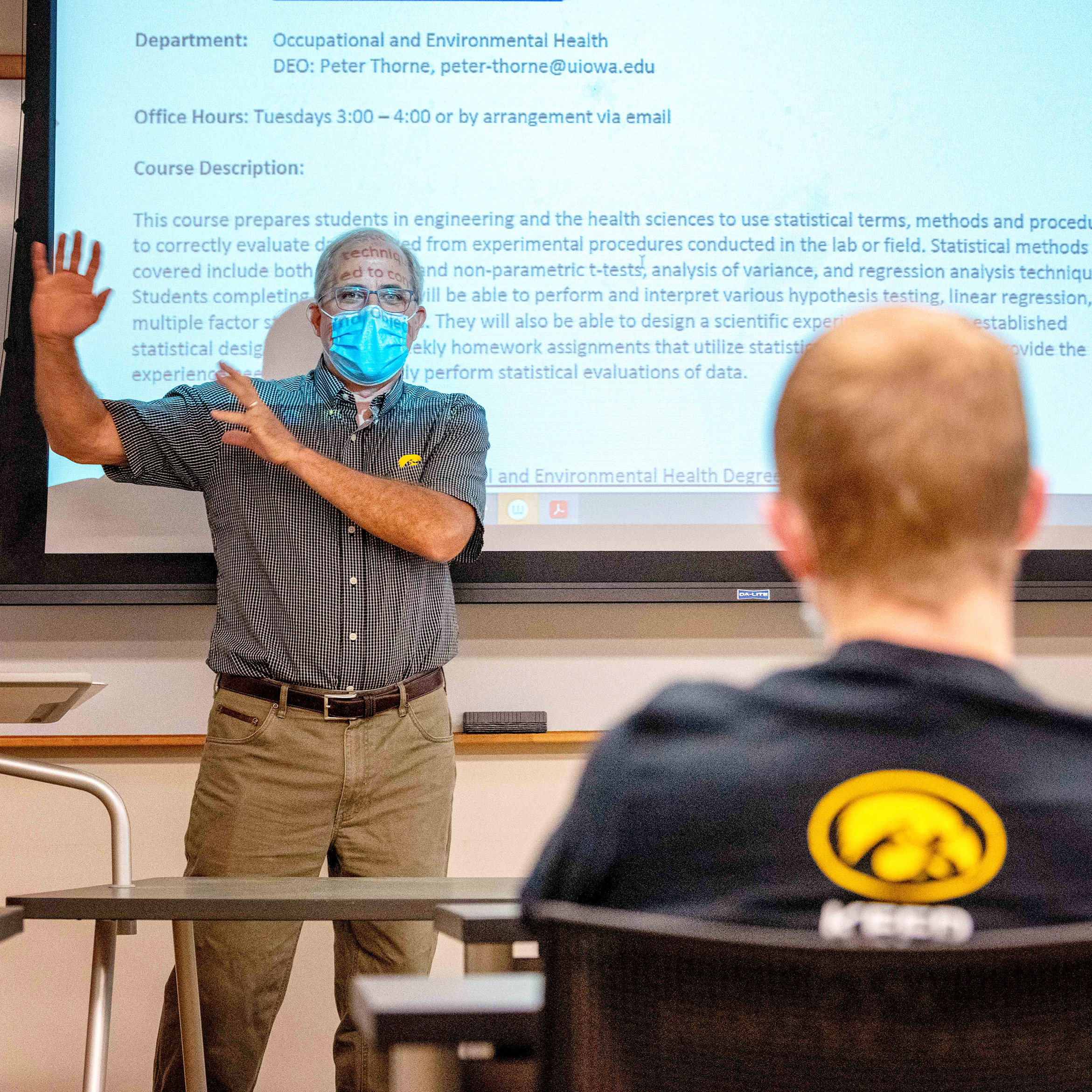 teacher standing in front of projector